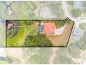 An aerial view of the property, with a backyard pool and a private dock and waterfront on a large lake at 1654 Marina Lake Dr, Kissimmee, FL 34744