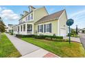 Charming home with an inviting front porch, manicured lawn, and attached garage at 1850 Treasure Cv, Celebration, FL 34747