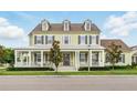 Charming two-story home with a welcoming front porch and beautifully landscaped front yard at 1850 Treasure Cv, Celebration, FL 34747