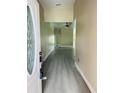 Inviting entryway with an oval glass insert door and modern gray flooring at 2385 Andrews Valley Dr, Kissimmee, FL 34758