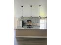 Beautiful kitchen island featuring granite countertops, stainless steel appliances, and pendant lighting at 2385 Andrews Valley Dr, Kissimmee, FL 34758