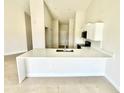 Bright kitchen with stainless steel appliances, a center island, and white cabinets at 2427 Continental Blvd, Orlando, FL 32808