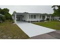 Welcoming home with covered parking, white exterior, and neatly kept landscaping at 2618 Brookside Cir, Mount Dora, FL 32757