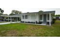 Inviting home featuring a carport, well-maintained lawn, and charming exterior details at 2618 Brookside Cir, Mount Dora, FL 32757