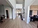 Bright entryway with wood floors that leads to a living space with staircase and office space at 2691 Cypress Tree Trl, St Cloud, FL 34772