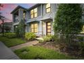Charming townhouse with stone accents, enhanced by verdant foliage and brick pathway at 2702 Giardino Loop, Kissimmee, FL 34741