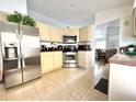 Well-equipped kitchen with stainless steel appliances, ample counter space, and tile flooring at 2711 Emerson Ln, Kissimmee, FL 34743