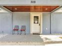 Inviting front porch with seating, a 'Welcome' mat, and a wood-paneled ceiling at 308 E Orange St, Kissimmee, FL 34744