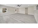 Bright, open living room with gray flooring, a ceiling fan, and neutral wall color at 308 E Orange St, Kissimmee, FL 34744