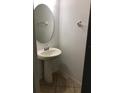 Half bathroom with pedestal sink, tile floors and white walls at 3319 Rodrick Cir, Orlando, FL 32824