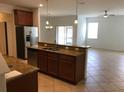 Kitchen with granite countertops, stainless steel appliances, and a breakfast bar overlooking the living space at 3319 Rodrick Cir, Orlando, FL 32824