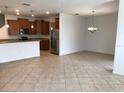 Open concept living space with tile floors flows into a dining area and kitchen at 3319 Rodrick Cir, Orlando, FL 32824