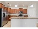 Modern kitchen featuring stainless steel appliances, granite countertops, and a central island at 3589 Cortland Dr, Davenport, FL 33837