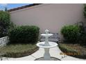 A serene courtyard with a decorative fountain and lush greenery at 386 San Jose Dr, Winter Haven, FL 33884