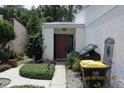 Charming home entrance with a red door and well-maintained landscaping at 386 San Jose Dr, Winter Haven, FL 33884