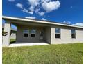 The backyard offers a covered patio and an expanse of green lawn at 4310 Seven Canyons Dr, Kissimmee, FL 34746