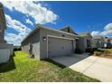 Charming one-story home boasts a two-car garage and manicured lawn at 4310 Seven Canyons Dr, Kissimmee, FL 34746