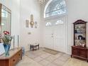 Bright foyer with tiled floor, high ceilings, decorative mirror, and an elegant chandelier at 4413 Chalfont Dr, Orlando, FL 32837