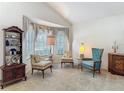 Cozy living room featuring comfortable seating, a decorative cabinet, and a large bay window with soft lighting at 4413 Chalfont Dr, Orlando, FL 32837