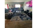 Spacious living room with a large leather sectional and decorative blue rug at 4714 Greycliff Prairie Dr, Kissimmee, FL 34758