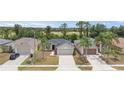 Well-kept single-Gathering home with a two-car garage and manicured lawn, nestled within a residential neighborhood at 5210 Silver Thistle Ln, St Cloud, FL 34772
