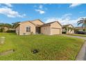 Well-maintained lawn with a charming single-story home and brick driveway at 5253 Pebble Beach Blvd, Winter Haven, FL 33884