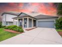 Charming single-Gathering home featuring a two-car garage, covered porch, and well-manicured lawn at 5876 Bar Ranch Rd, St Cloud, FL 34771