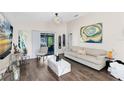 Bright living room with modern decor, sleek coffee table, leading to outdoor screened patio at 106 Edgewater Dr, St Cloud, FL 34769