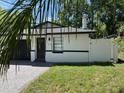 Charming single-story home with a dark garage door and brick-paved driveway and manicured lawn at 1256 S Bumby Ave, Orlando, FL 32806