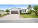 Beautiful one-story home with a lush lawn, a front bay window and a large driveway at 1688 Tamarind Rd, Davenport, FL 33896