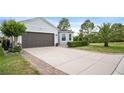 A beautiful house with a paved driveway and manicured lawn in a lovely neighborhood at 1688 Tamarind Rd, Davenport, FL 33896