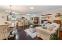 Inviting open-concept living room featuring hardwood floors, neutral paint, and plenty of natural light at 17 Juniper Dr, Davenport, FL 33837