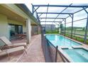 Relaxing screened-in pool area with lounge chairs and a hot tub, perfect for outdoor entertainment at 2147 Tripoli Ct, Kissimmee, FL 34747