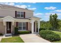 Well-kept townhome with neat front yard featuring lush greenery and an inviting entryway at 2322 Silver Palm Dr, Kissimmee, FL 34747