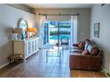 Bright living room with sliding glass doors leading to a pool area, filled with natural light at 2341 Stone Cross Cir, Orlando, FL 32828