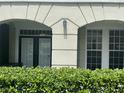 Close up on exterior trim and windows above a manicured green shrub, showcasing architectural details at 239 Longview Ave # 107, Celebration, FL 34747