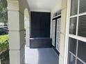 Inviting covered porch area with decorative shutters, a storage bench, and views of the well-maintained property at 239 Longview Ave # 107, Celebration, FL 34747
