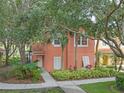 Charming home with a terra cotta roof, lush tropical landscaping, and a welcoming walkway to the front door at 3015 Yellow Lantana Ln, Kissimmee, FL 34747