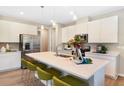 Modern kitchen with stainless steel appliances, a spacious island, and stylish seating for casual dining at 5228 Bee Balm St, Lake Hamilton, FL 33851