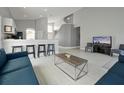 Bright living space with modern decor, light tile flooring, and an open floor plan at 553 Bailey Cir, Davenport, FL 33897