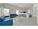 Inviting living room with modern decor, light tile flooring, and an open-concept layout at 553 Bailey Cir, Davenport, FL 33897