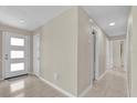 Inviting foyer with tile flooring, neutral walls, and a stylish front door at 6824 Chaucer Ln, Orlando, FL 32809