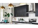 Modern kitchen showcasing stylish black cabinets, stainless steel appliances, and a sleek white countertop at 729 Lake Dell Ave, Dundee, FL 33838
