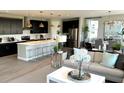 Open-concept living room with modern furnishings, sleek kitchen island, and contemporary decor at 729 Lake Dell Ave, Dundee, FL 33838