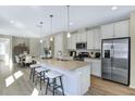 Spacious kitchen featuring a center island, stainless steel appliances, and ample cabinet space for modern living at 811 Lake Dell Rd, Dundee, FL 33838