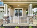 Inviting front porch with stone accents on the columns, providing a cozy outdoor space with a white railing detail at 8635 Tallfield Ave, Orlando, FL 32832