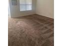 Cozy bedroom with natural light from a large window and neutral carpet flooring at 1895 Hickory Bluff Rd, Kissimmee, FL 34744