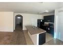 Bright kitchen with modern appliances, a convenient breakfast bar, and open access to the adjacent room at 1895 Hickory Bluff Rd, Kissimmee, FL 34744