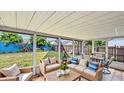Inviting sunroom furnished with comfortable seating and views of the backyard at 1013 Carefree Cove Dr, Winter Haven, FL 33881