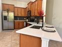 Spacious kitchen showcasing quartz countertops, stainless steel appliances, and ample cabinet space at 10734 Dawson Lily Way # S, Orlando, FL 32832